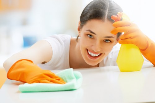 Professional cleaner disinfecting a short-term rental kitchen