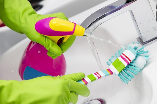 Office cleaning team sanitizing desks and shared surfaces